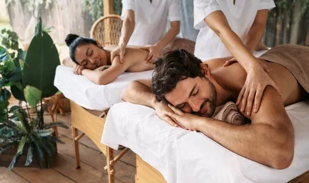 Two guests relaxing during side-by-side massages